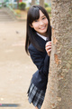 Kasugano yui standing behind tree wearing uniform