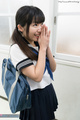 Hands clasped together wearing uniform bag over her shoulder