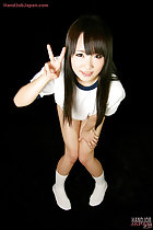 Leaning forward flashing victory sign hand resting on her thigh knees pressed together in white socks