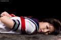 Kogal lying face down arms tied behind her back.jpg