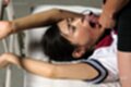 On her back arms raised wearing uniform cock pressed to her mouth