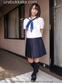 Standing outside home wearing seifuku uniform hands behind her back.jpg